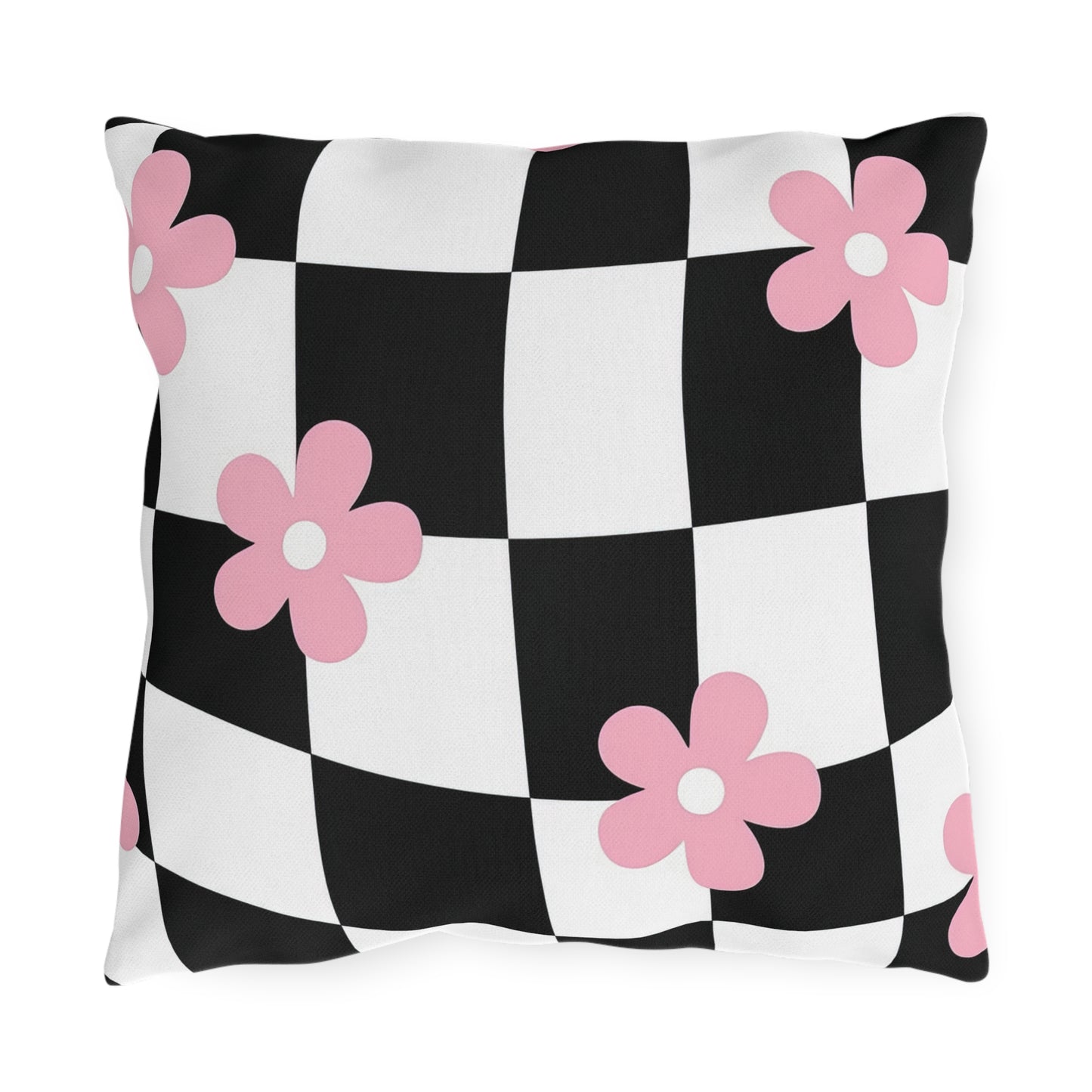 Black and white checkered outdoor pillow with soft pink floral print on a patio bench