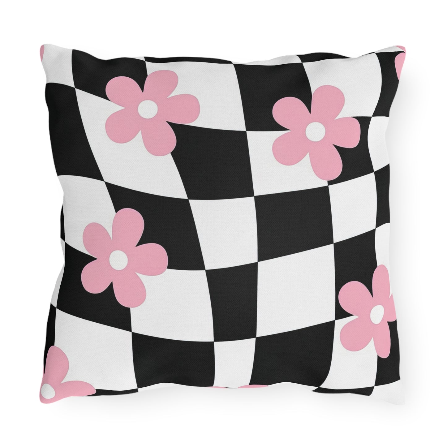 Decorative patio throw pillow in black, white, and pink displayed on porch furniture