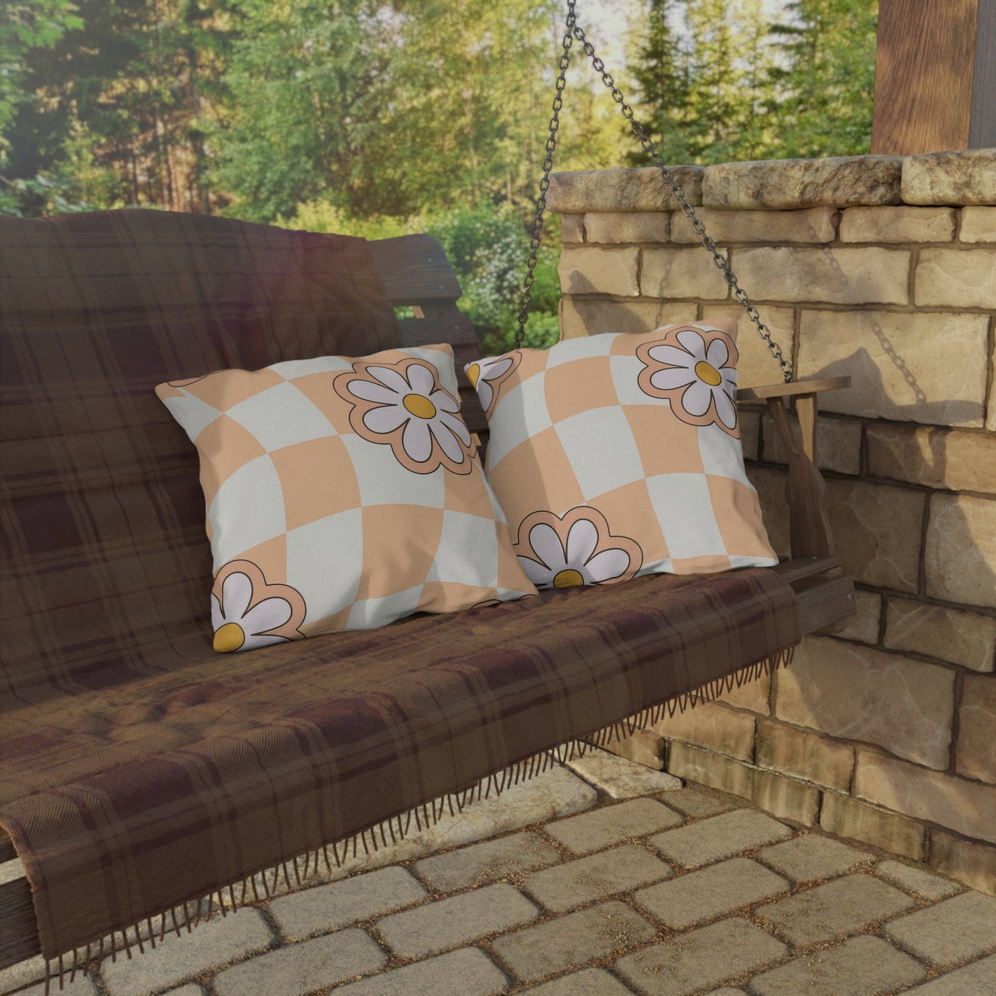 Single floral pillow in daisy print arranged with neutral patio furniture