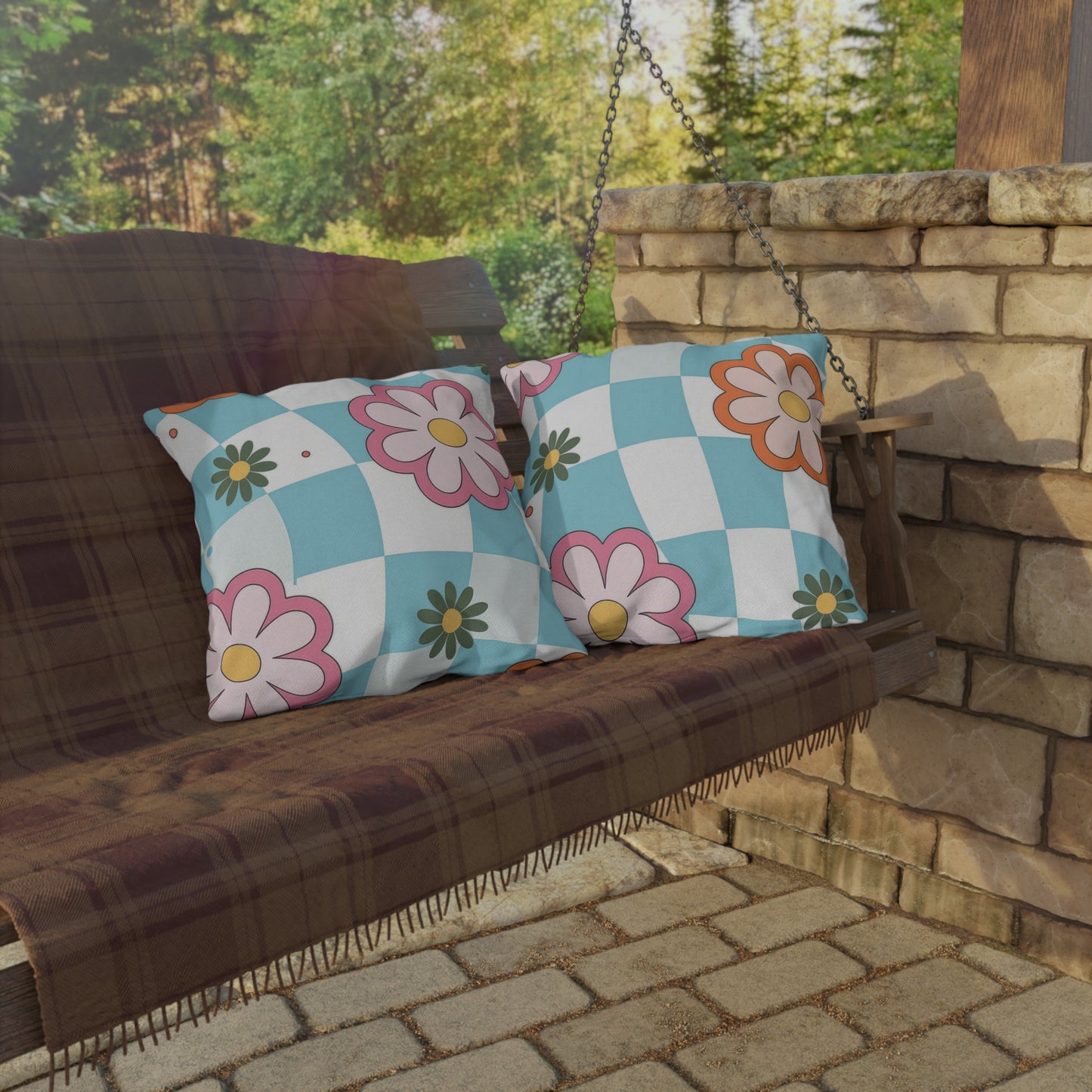 Vibrant square cushion in colorful flower print next to potted plants