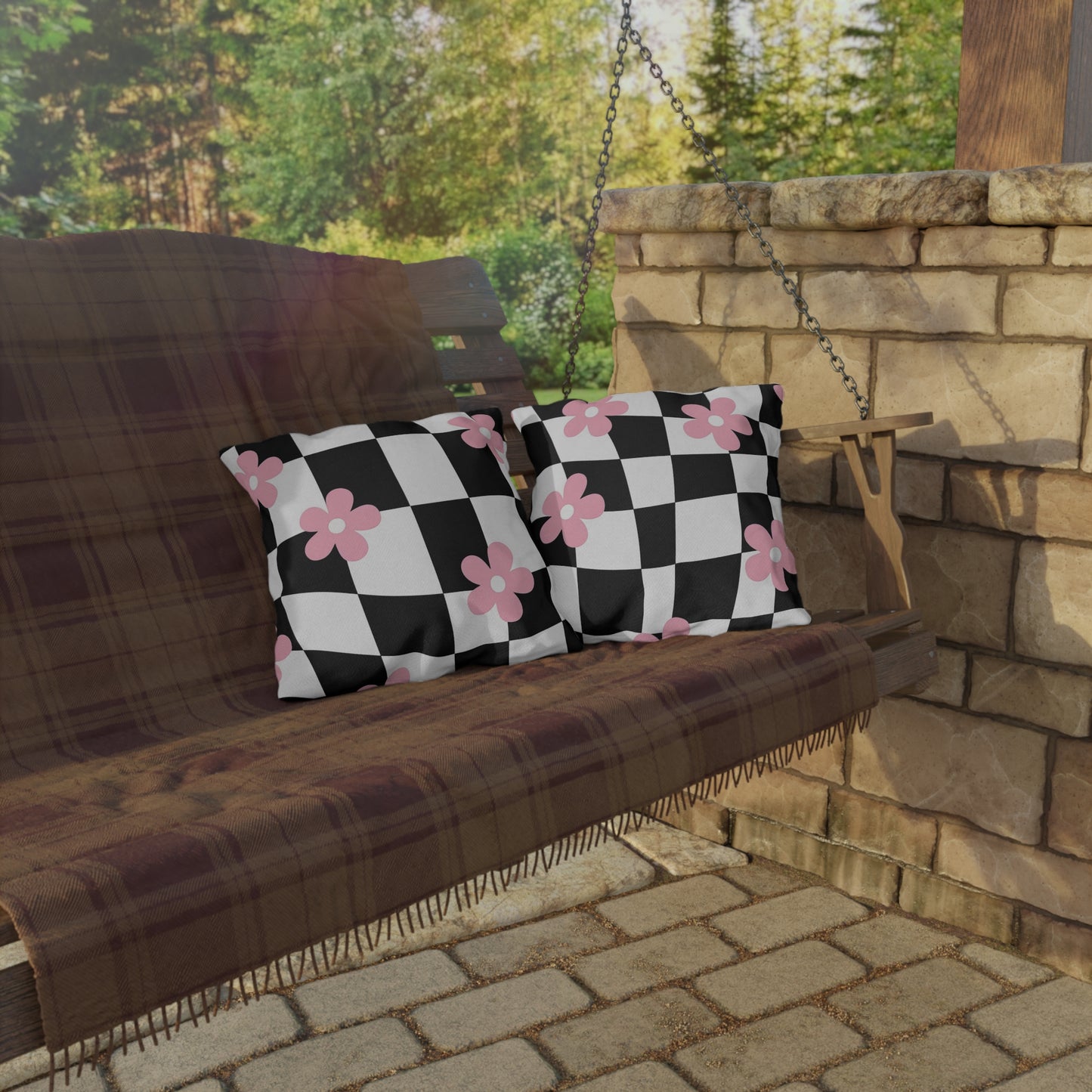 Modern floral pillow with pink flower accents and black grid for stylish outdoor use