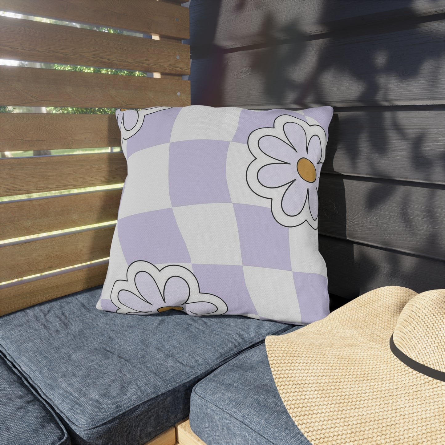 Floral print square cushion placed on porch bench with spring flowers