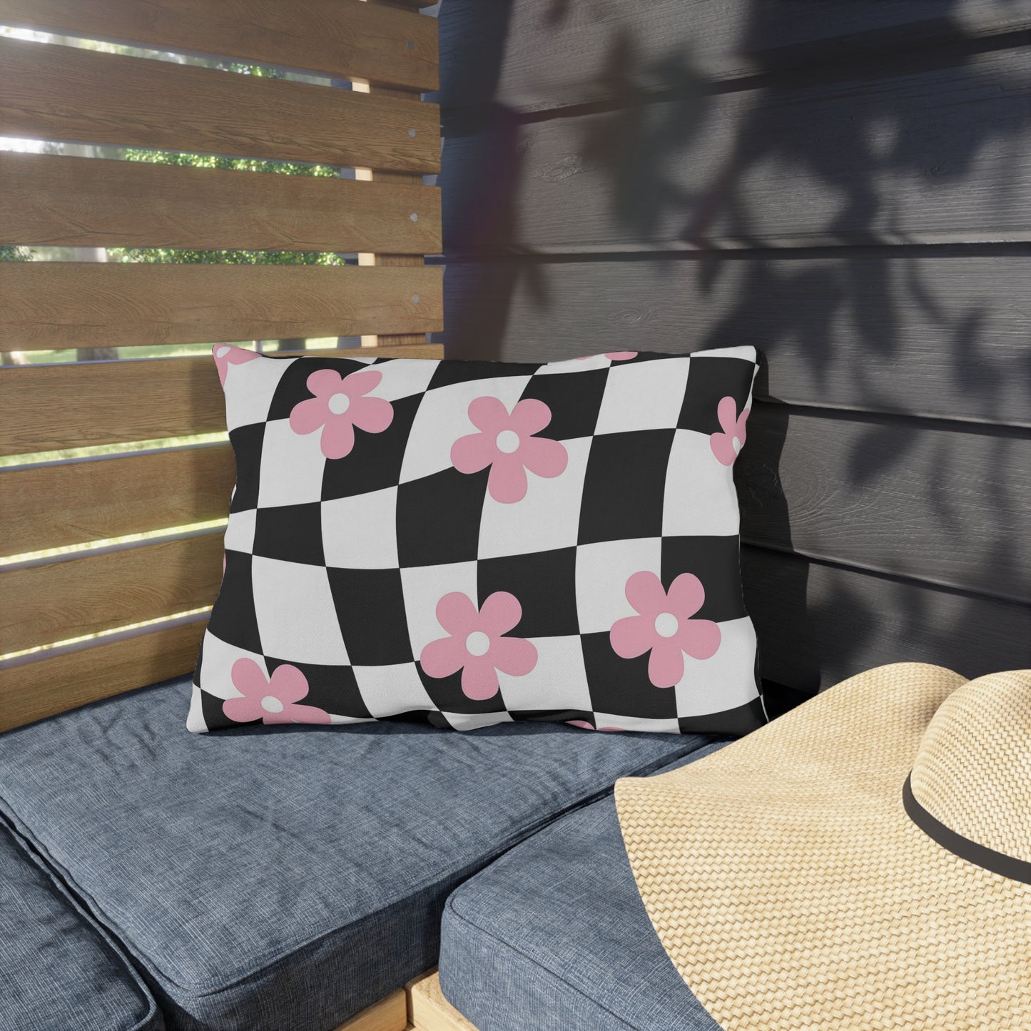 Garden pillow with checkered floral pattern shown on modern balcony furniture