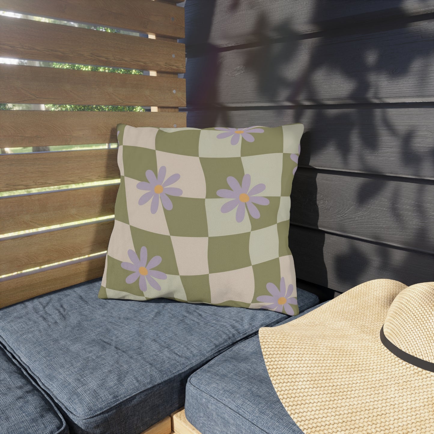 Square floral pillow accentuating patio furniture with vibrant blooms