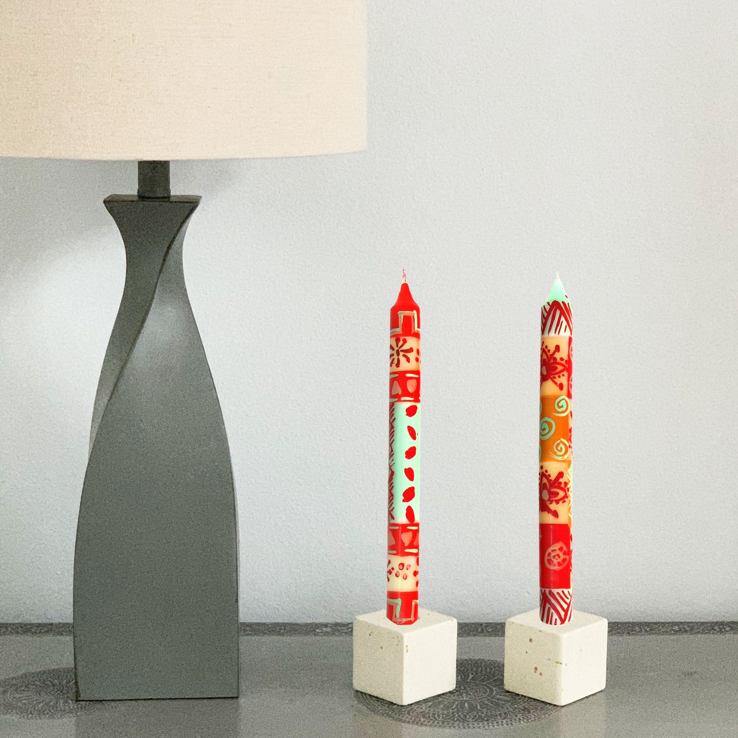 Close-up of individually painted African-style candles with geometric patterns