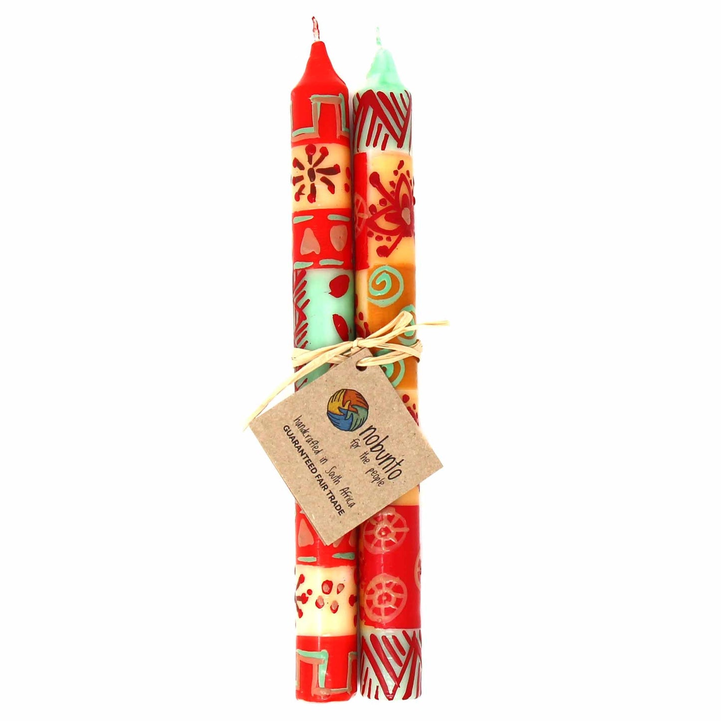 Hand-painted taper candles with traditional Owoduni design in earthy colors