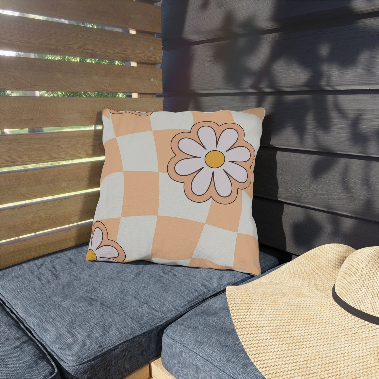 Square garden cushion with floral design shown on porch swing