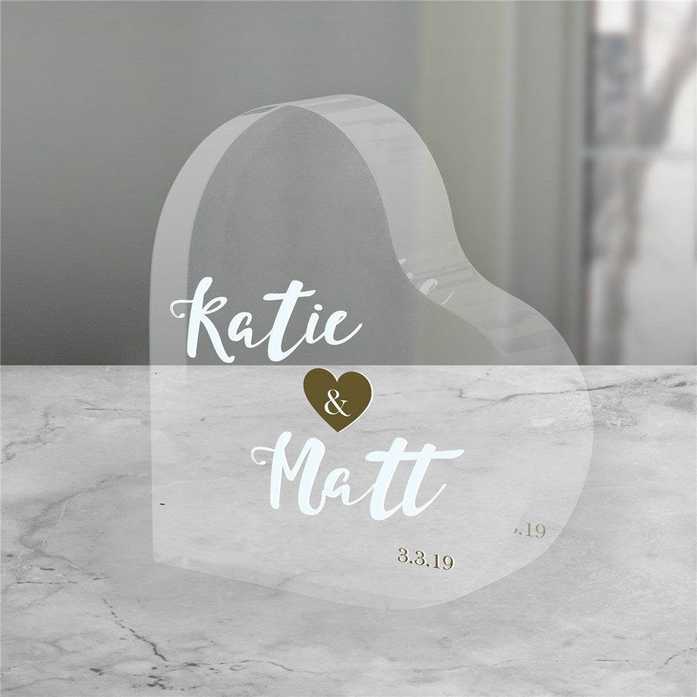 Personalized acrylic wedding cake topper with engraved bride and groom names and wedding date. Elegant, clear acrylic design for modern weddings.
