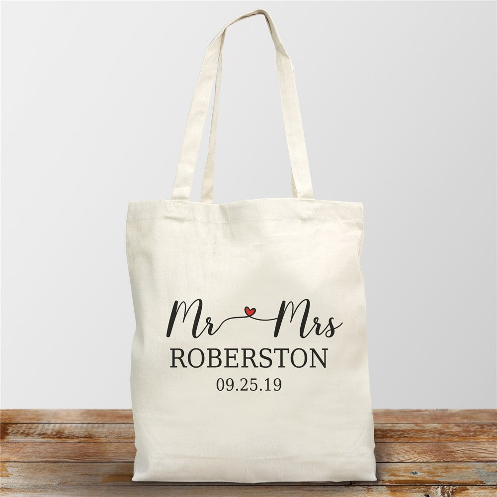 Canvas tote bag with "Mr. and Mrs." text, personalized with last name and date, displayed on a white background.