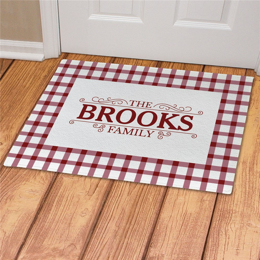 Personalized gingham doormat with custom name engraving. Available in teal, gray, black, or burgundy with a soft fleece surface and latex backing.