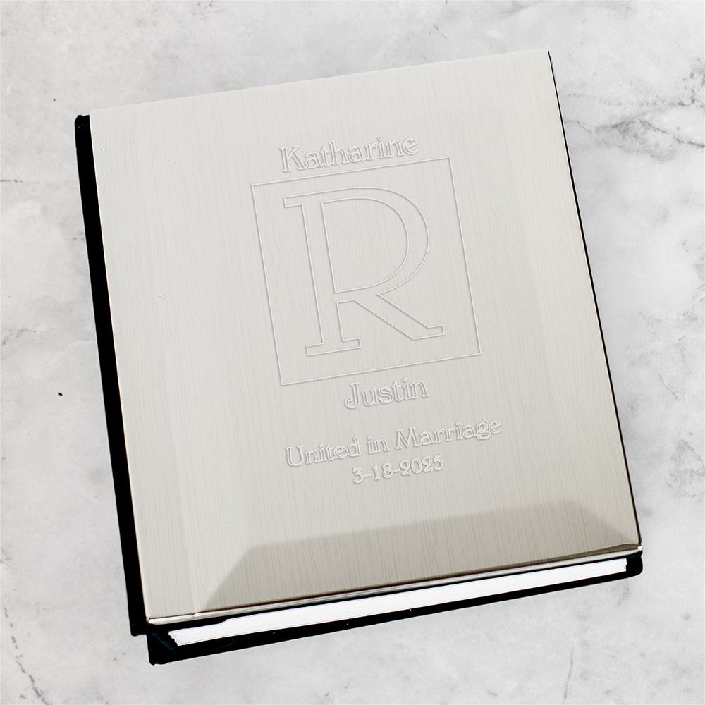 Engraved silver wedding photo album with personalized names and date