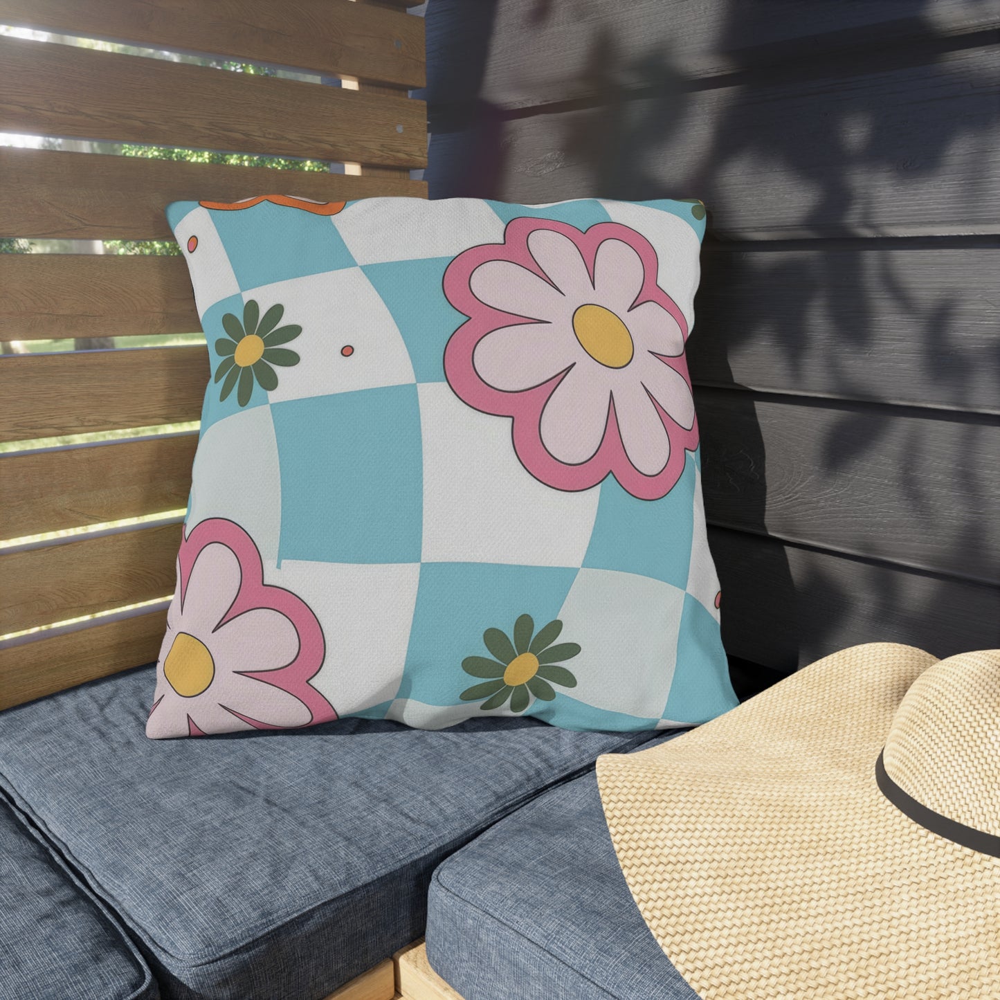 Weather-resistant floral cushion styled on porch chair with plants