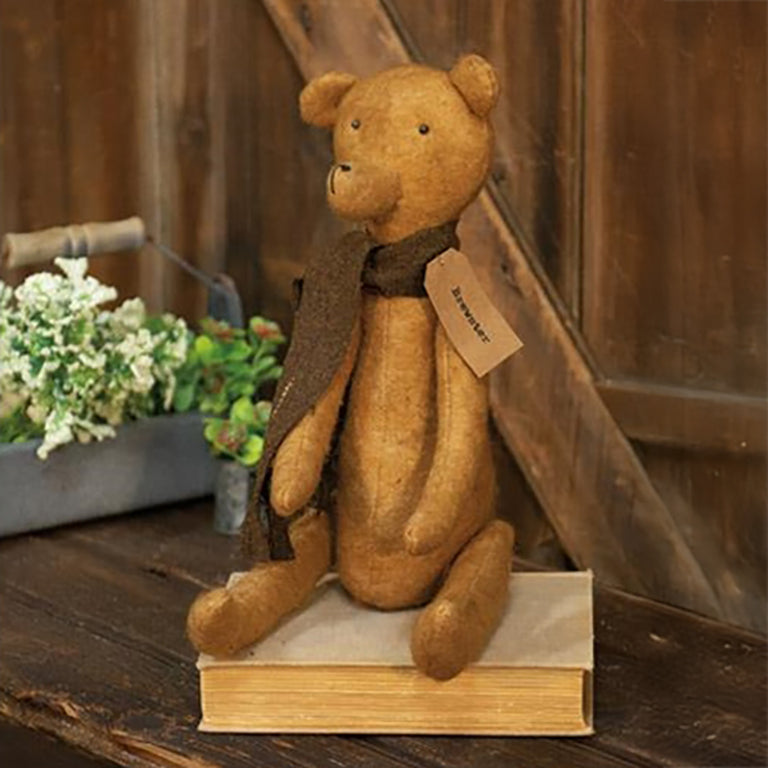 Primitive stuffed bear with brown scarf, fabric patch, and name tag for rustic décor