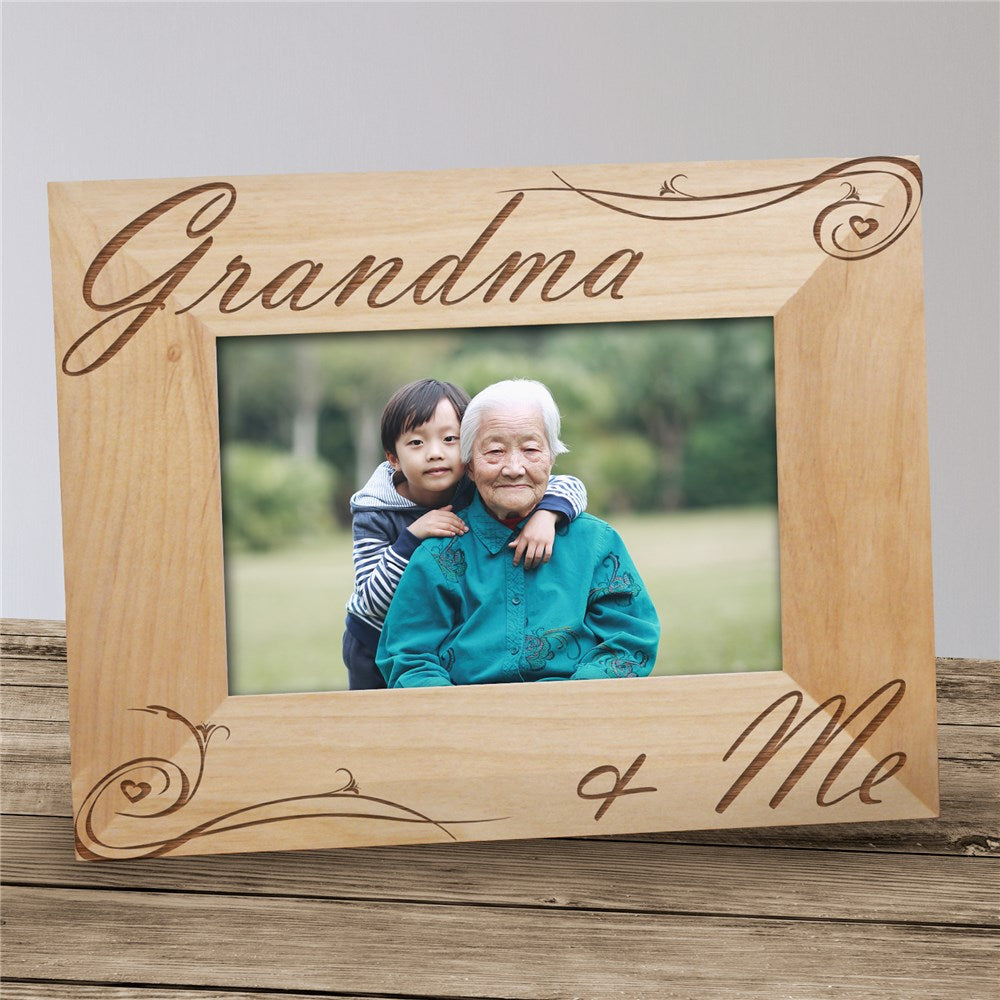 Personalized wooden picture frame engraved with “Grandma and Me,” with an easel back for tabletop display.
