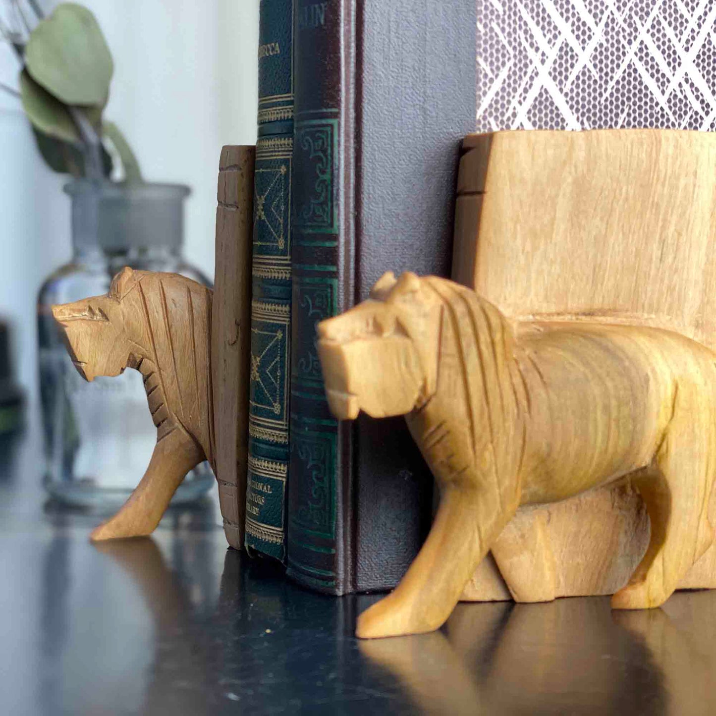 Natural wood grain detail on carved lion bookend