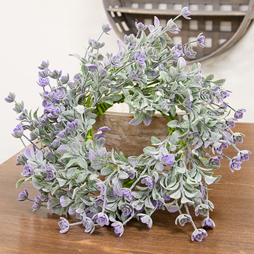 Faux lavender candle ring with lamb’s ear greenery on green-wrapped base