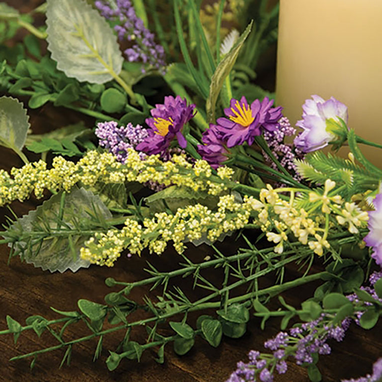 Spring candle ring with lavender buds and mixed greenery on green-wrapped base