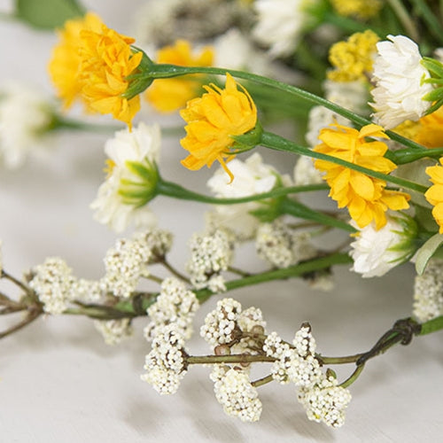 Soft foamy greenery wreath with layered cream and yellow blooms for front door