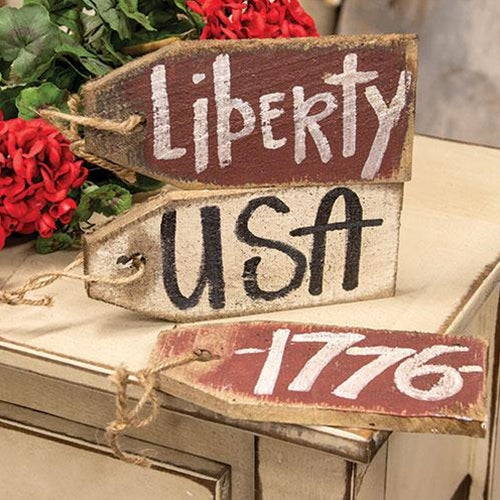 Rustic wooden patriotic tag with jute rope and the word “liberty” in bold lettering – distressed red and white Americana decor