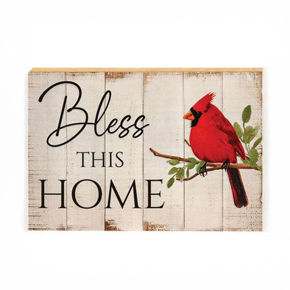 Wooden block sign with “Bless This Home” and red cardinal artwork on a distressed white shiplap background