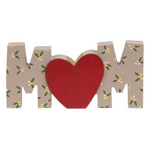 “Mom” wood word cutout featuring dainty cream and green flower pattern