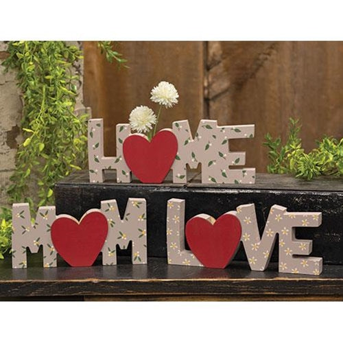 Set of three taupe wooden blocks with floral patterns and heart-shaped mini vases