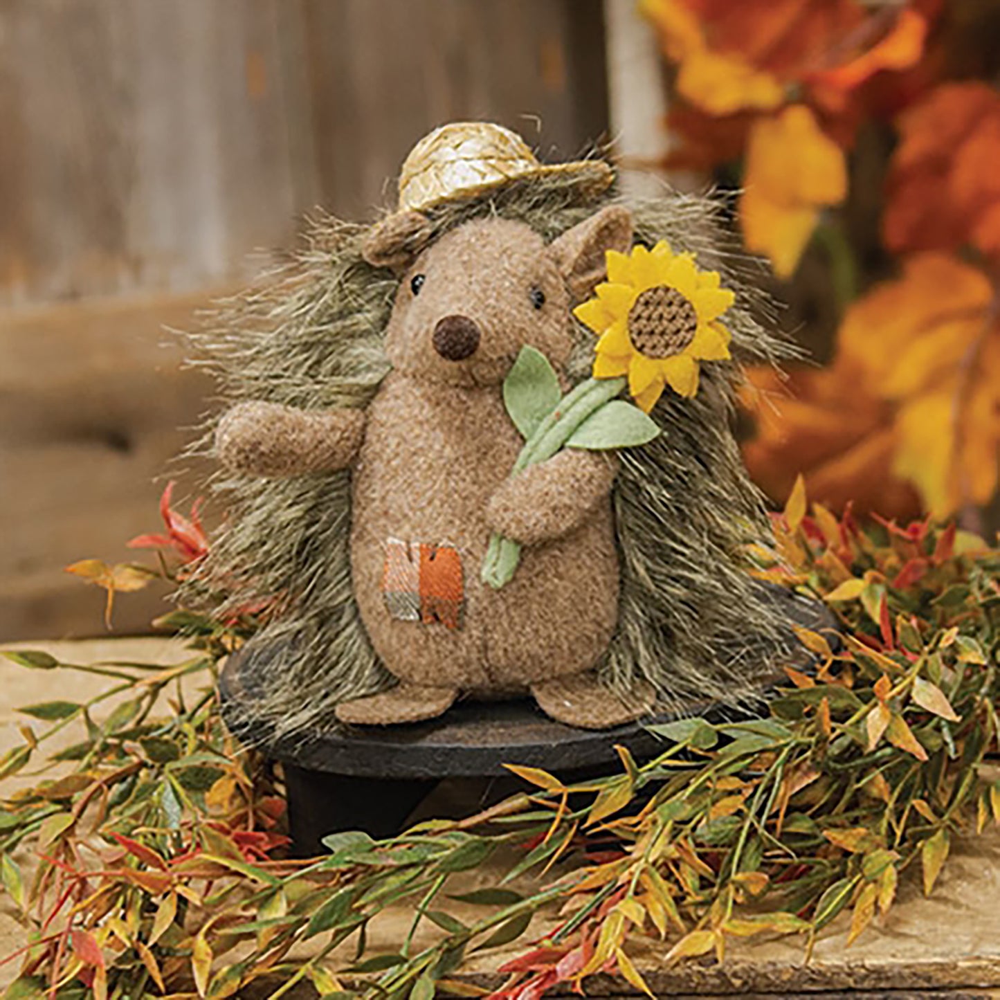 Stuffed hedgehog plush with straw hat and felt sunflower, freestanding autumn decor with brown fuzzy fabric and orange patch