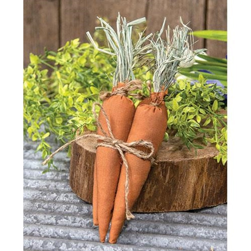 Set of four primitive fabric carrots with green raffia tops and jute bow