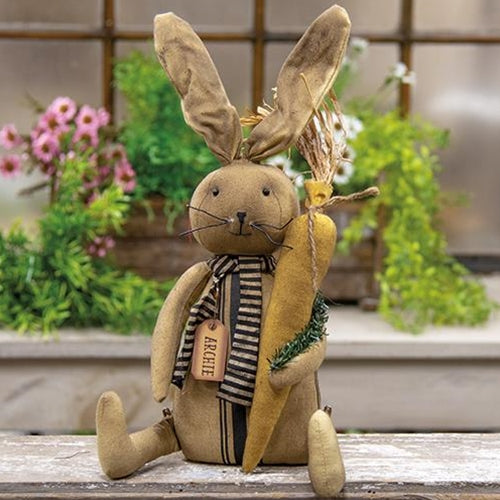 Primitive fabric bunny doll with wired ears, striped scarf, and carrot accent
