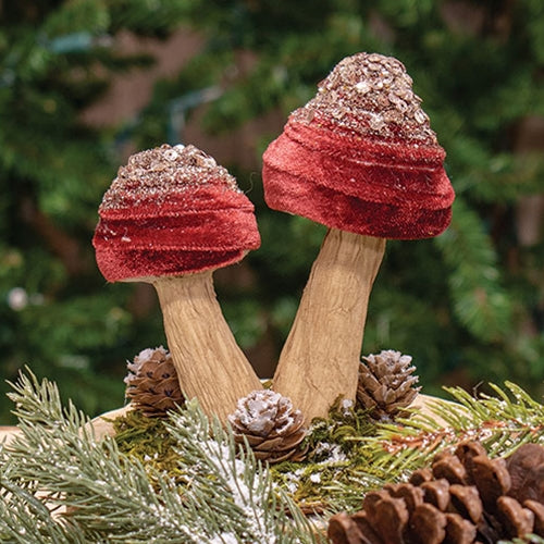 Burgundy velvet mushroom sitter with gold glitter accents and pinecone details