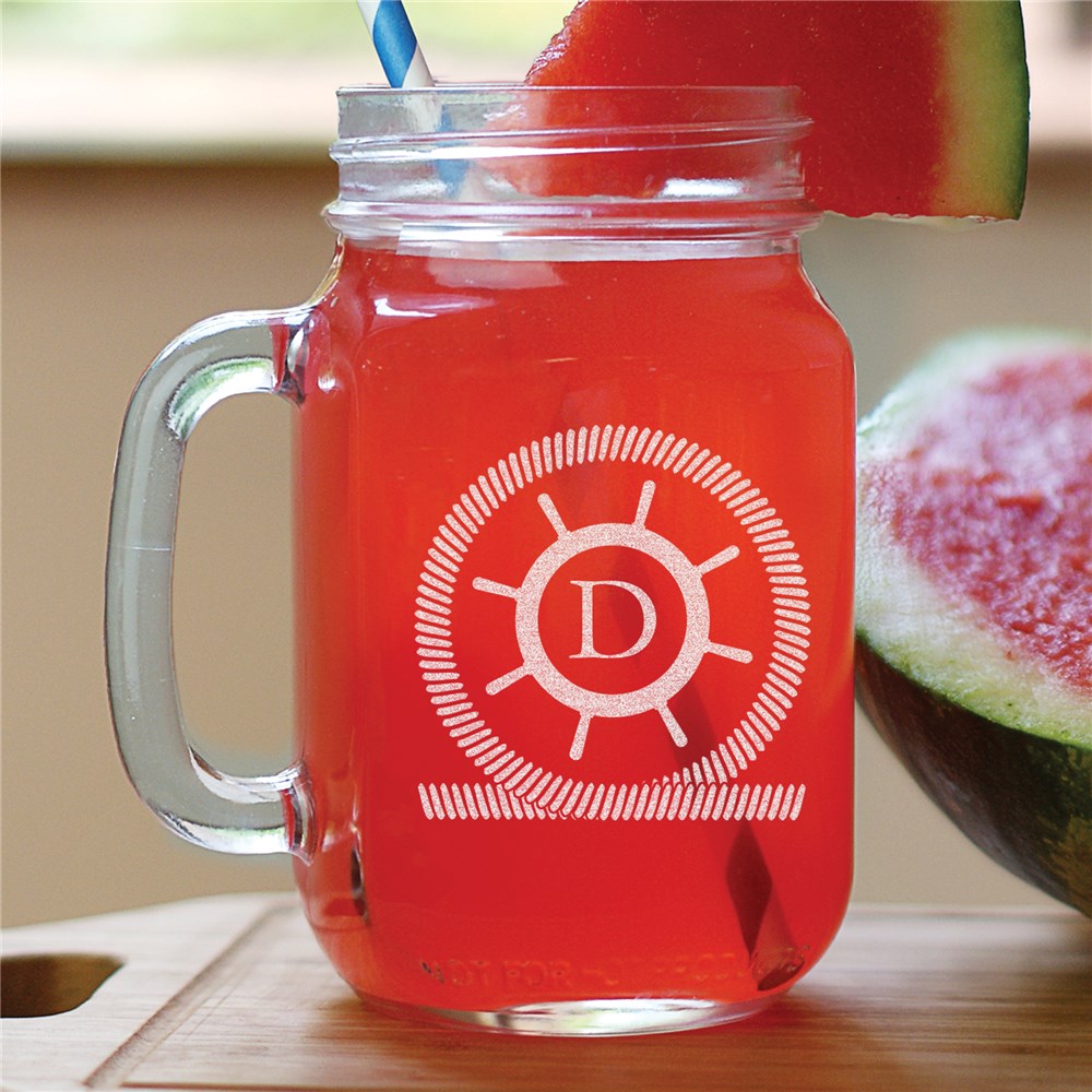 Engraved mason jar with ship’s wheel design and personalized initial, nautical glassware