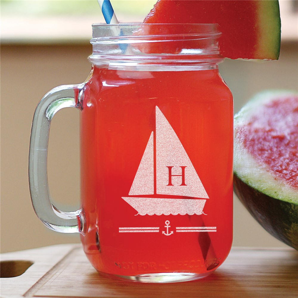 16 oz mason jar with engraved initial and curved handle on a wood surface