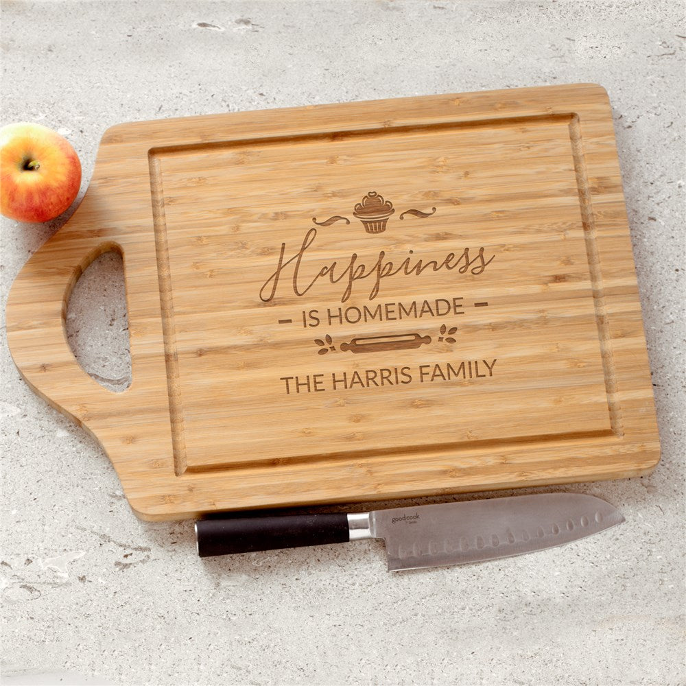 Engraved bamboo cutting board with “Happiness Is Homemade” and cupcake design
