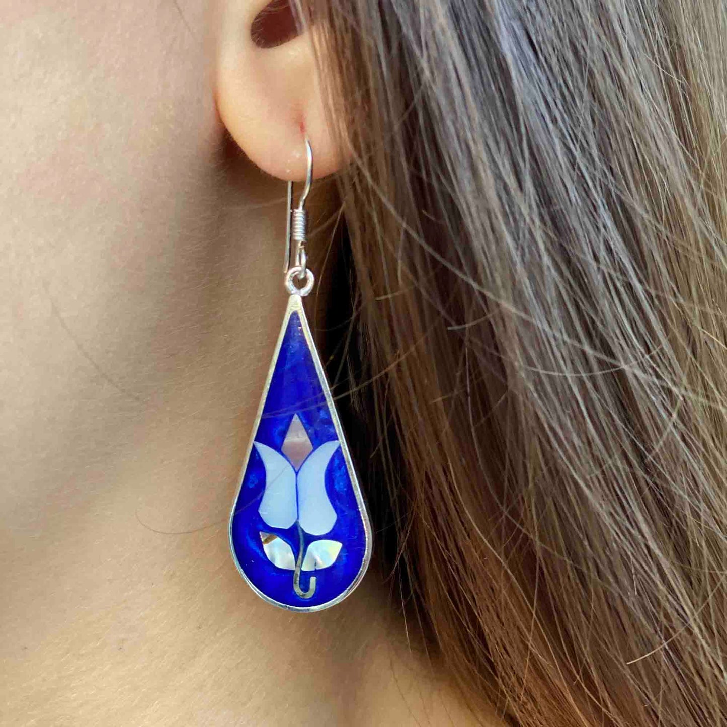 Fair trade abalone shell earrings with iridescent colors and silver finish
