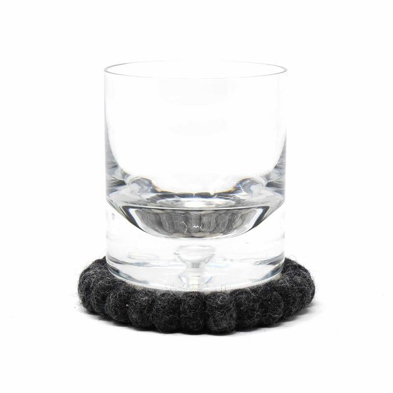 Set of four round felt coasters in neutral floral pattern