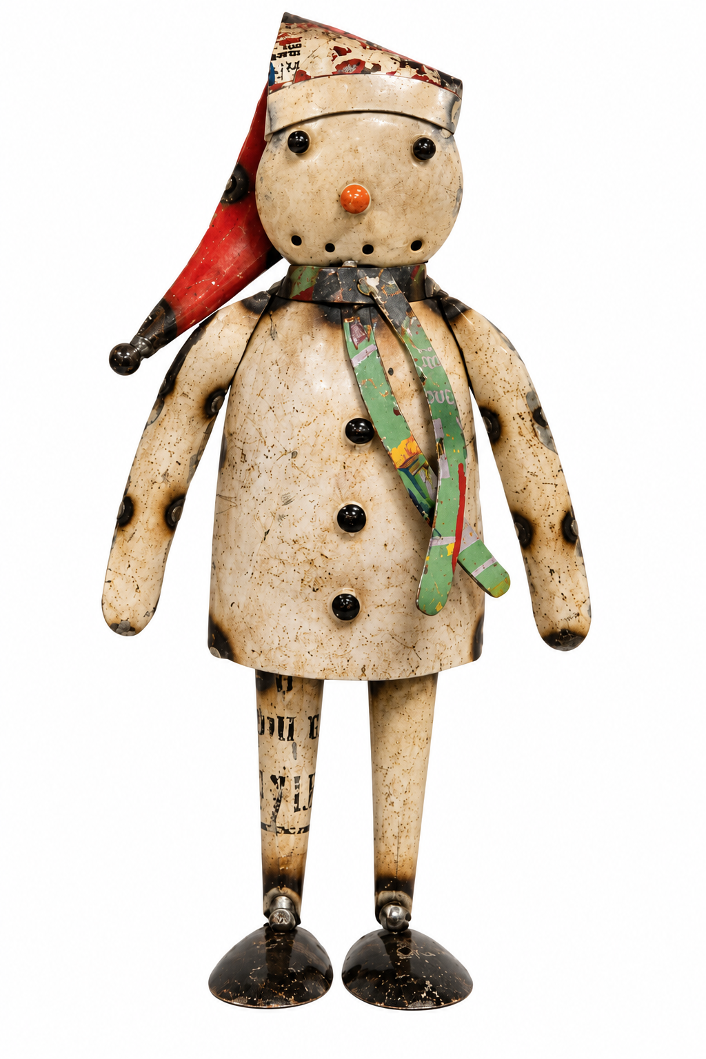 A rustic, handmade snowman figurine crafted from recycled paper and cardboard, featuring a cream-colored coat, black buttons, a green and red patterned scarf, and a red Santa hat, isolated on a white background.