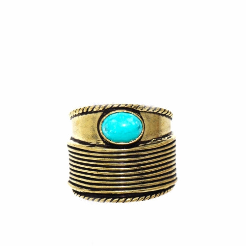 Close-up of handmade turquoise statement ring with an adjustable brass band