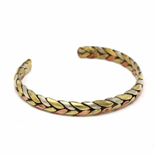 Handmade copper and brass cuff bracelet with Tibetan healing design, crafted in Nepal for wellness and energy balance.