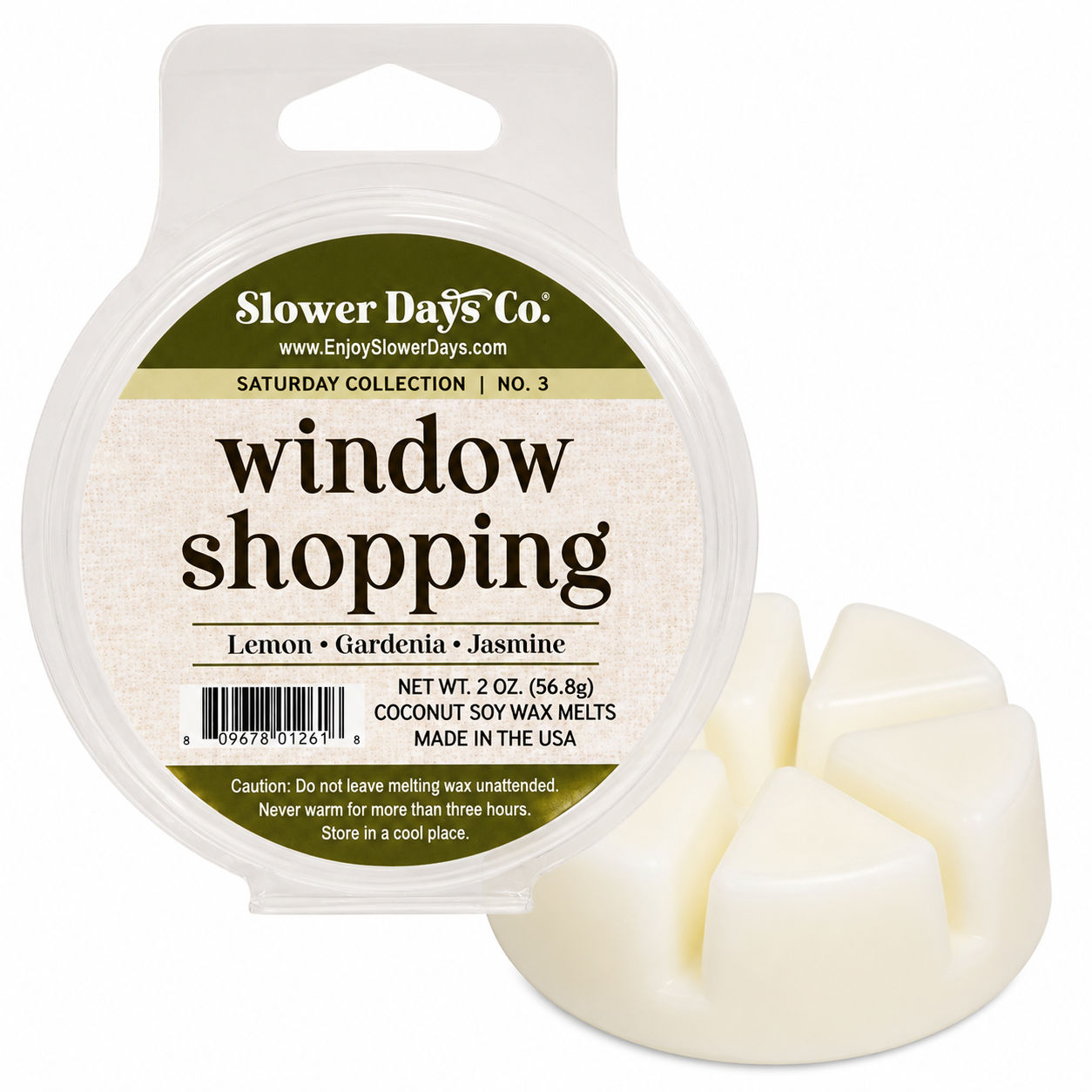 A 2 oz round plastic tub of Slower Days Co. 'window shopping' lemon gardenia jasmine coconut soy wax melts, shown next to three pale cream wax melts on a white background.