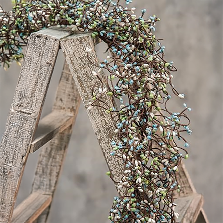 Rustic pip berry garland with teal, ivory, and green berries on brown wrapped stems