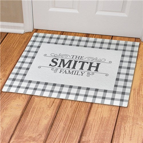 Custom name welcome mat featuring a classic gingham pattern. Ideal for indoor or covered outdoor use with non-slip latex backing.