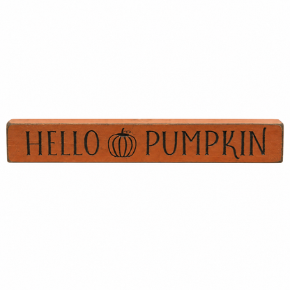 A rectangular wooden sign with a warm orange-brown finish, featuring the words 'HELLO PUMPKIN' in black lettering and a small black pumpkin illustration in the center, shown on a plain white background.