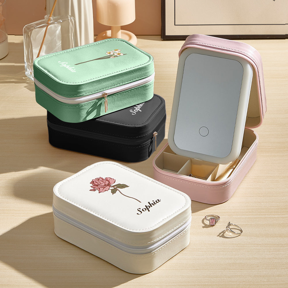 A view of all color options of the personalized jewelry box, with the pink version open but the light off, and the other colors stacked neatly beside it, showcasing the variety and sleek design.