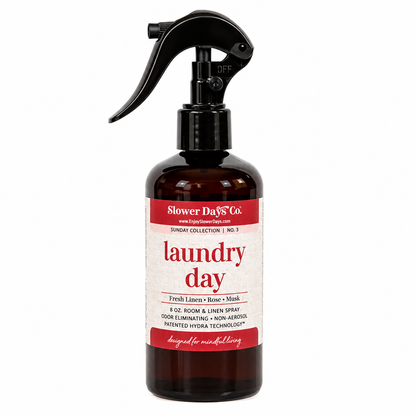 Laundry Day Room & Linen Spray with fresh linen, rose, and musk fragrance in a dark Slower Days Sunday collection bottle.