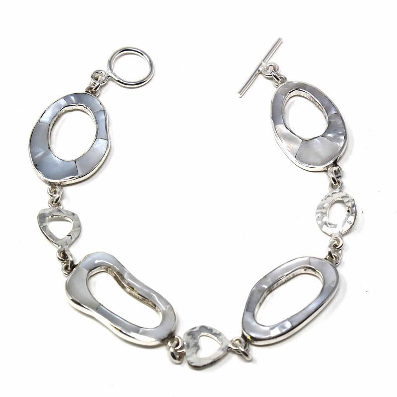 Handcrafted bracelet with shimmering mother-of-pearl circle links and alpaca silver