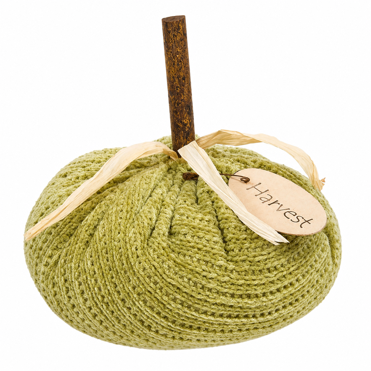 Green sweater pumpkin styled in a fall display with a plush knit finish, natural wood stem, dried grass, and pinned Harvest tag.