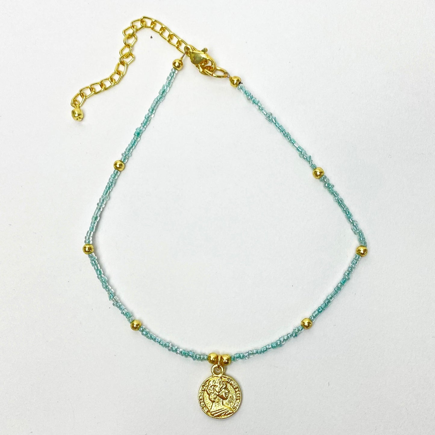 Fair trade choker with polished brass coin and delicate blue beads