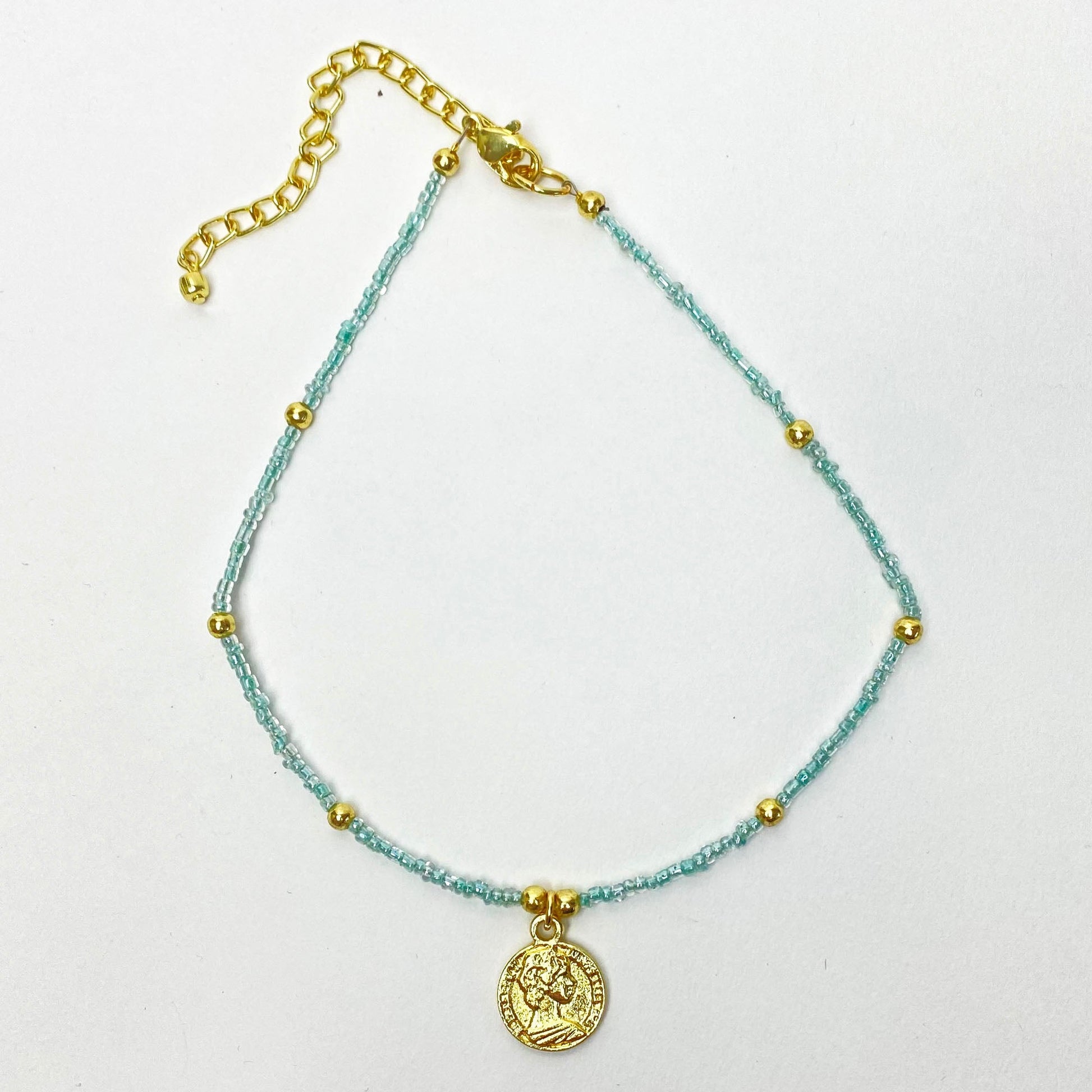 Fair trade choker with polished brass coin and delicate blue beads