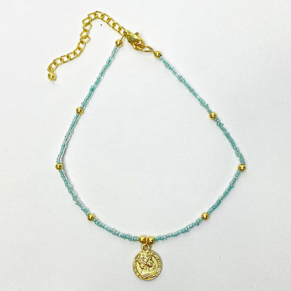 Fair trade choker with polished brass coin and delicate blue beads