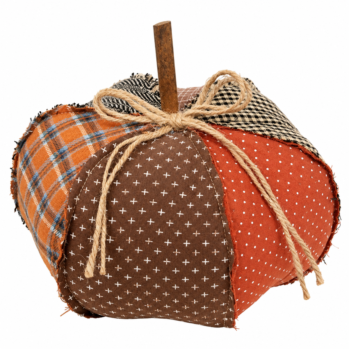 A handmade fabric patchwork pumpkin decoration with a rustic wooden stem, featuring orange plaid, brown with white cross pattern, orange with white polka dots, and black-and-white gingham sections tied together with a jute rope bow.